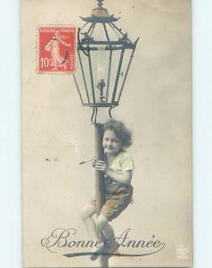 1911 rppc controversial YOUNG KID ON STREET LANTERN SMOKES TOBACCO CIGAR HM1211