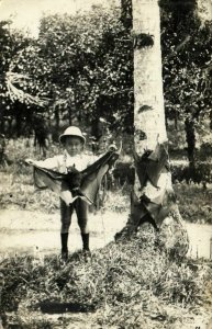 PC CPA SINGAPORE, BOY HOLDING A GIANT BAT, Vintage REAL PHOTO Postcard (b3003)