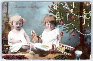 1907-10's BAREFOOT LITTLE GIRLS UNDER CHRISTMAS TREE TOY HORSE DRUM POSTCARD