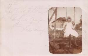 A093 Real Photo 1908 Prien Bavaria Girl in white dress sitting in swing postcard
