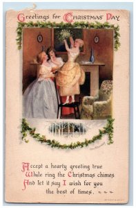 1921 Christmas Greetings Pretty Girls Standing Chair Holly Berries Wolf Postcard