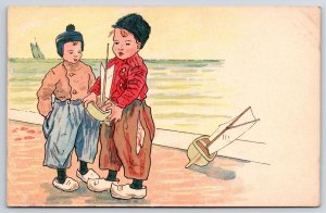 Two Young Boy Playing Sailing Boat In The Ocean Postcard