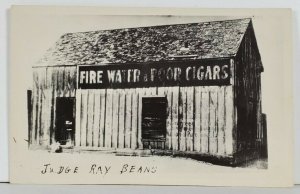 RPPC BUILDING ADVERTISING FIRE WATER & POOR CIGARS OLD WEST POSTCARD Q13