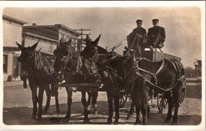 Real Photo Postcard Four Horses Pulling Wagon Cart and Two Men on City Street