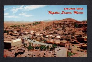 AZ Nogales Arizona International Fence Postcard Sonora Mexico Saludos Desde