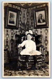 1910 Little Girl Sitting On Chair House Interior Owatonna MN RPPC Photo Postcard