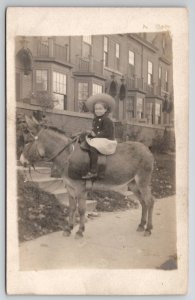 RPPC Cute Girl Big Straw Hat Sitting On Donkey Sidewalk c1910 Postcard S28