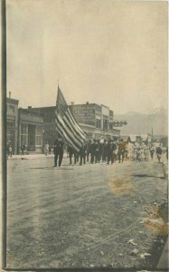 c1910 Western Sterling Block Garage Patriotic Parade Gentles Store RPPC Postcard