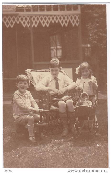 RP; Boy reading to siblings, girl with doll in buggy, 00-10s