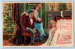 c1910's Christmas Family Child Girl Praying Hanging Stocking Fireplace Postcard