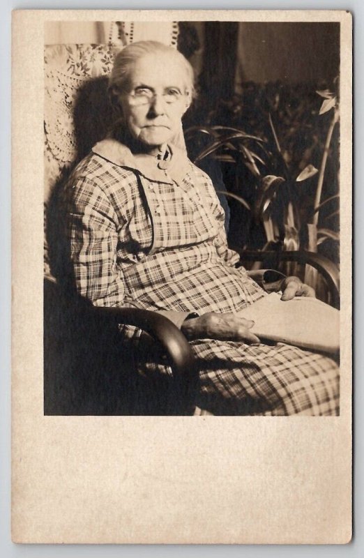 RPPC Sweetest Old Woman plaid Drees with Book in Chair c1918 Postcard J30