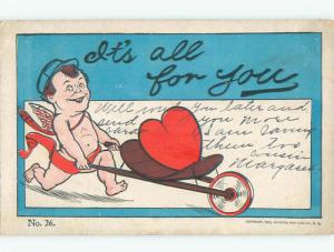 Pre-1907 valentine CUPID DELIVERS HEART ON WHEELBARROW k5427