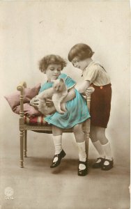 Hand Colored RPPC Postcard Little Girls Hold White Cat Belgium