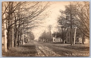 K32/ Portland New York RPPC Postcard c1910 Main Street Store Homes 395