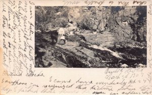 WOMAN & DOG ON RIVER ROCK~1909 REAL PHOTO POSTCARD FROM BEULAH CO TO CHANNING TX