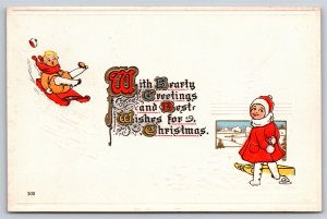 Holiday~Girl & Boy On Sleds Hearty Greeting Christmas~Vintage Postcard