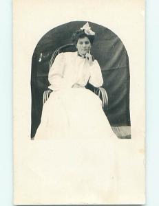 Pre-1918 rppc PRETTY GIRL WITH BOW IN HAIR SITTING IN CHAIR r5851