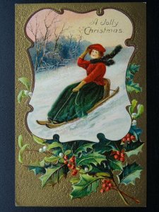 A JOLLY CHRISTMAS Lady on Sledge & Holly c1910 Embossed Postcard