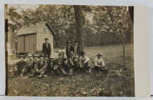 RPPC Handsome Group of Men and Young Boys Rustic Outdoor Cabin Scene Postcard Q7