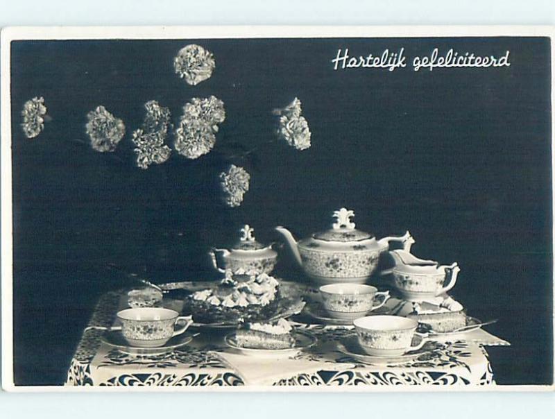 1942 rppc ANTIQUE TEAPOT AND TEA CUPS ON THE TABLE HM0837