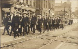 Men March/Parade in Street w/ Guns Rifles c1910 Real Photo Postcard dcn
