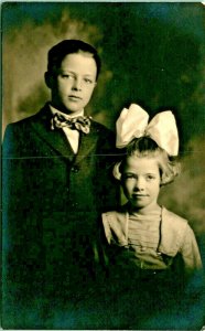 RPPC Adorable Children Boy w Bowtie Girl Giant Hair Bow Studio View Postcard D7