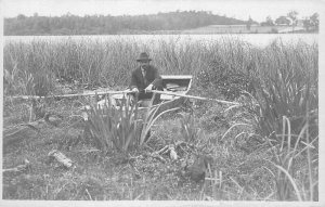 C-1910 Dry land touch rowing boat man hat RPPC Photo Postcard 21-11780