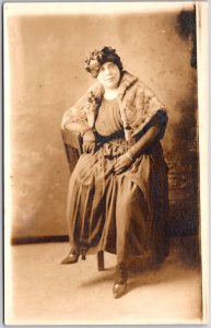 Fat Lady Long Dress Headress Sitting on Chair Real Photo RPPC Postcard