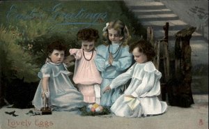 Easter Children Girls Sit Around Eggs Play Tuck c1900s-10s Postcard