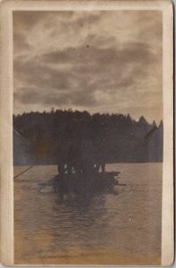 RPPC Silhouettes of Men Rowing Wood Raft c1910 Postcard B27