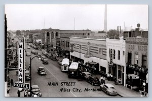 JH2/ Miles City Montana RPPC Postcard c1950s Main Street Milligan Hotel 183