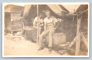 RPPC Men Sitting on Trunks Under a Tent AZO 1918-1930 VINTAGE Postcard 1285