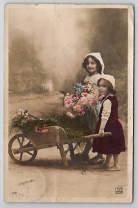 RPPC Darling Young Girls Wheelbarrow of Flowers Studio Real Photo Postcard Y25