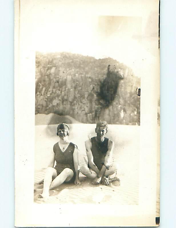 Pre-1918 rppc RISQUE - GIRL IN BATHING SUIT AT BEACH WITH GUY r5855