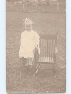 Pre-1907 rppc FROWNING GIRL HOLDS UMBRELLA BY CHILD SIZED ROCKING CHAIR HM0453