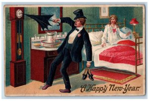 1910 New Year Druck Man Umbrella Adjusting Clock Embossed Haverhill MA Postcard