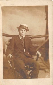 1920s RPPC Real Photo Postcard Young Man Seated In Suit and Straw Hat