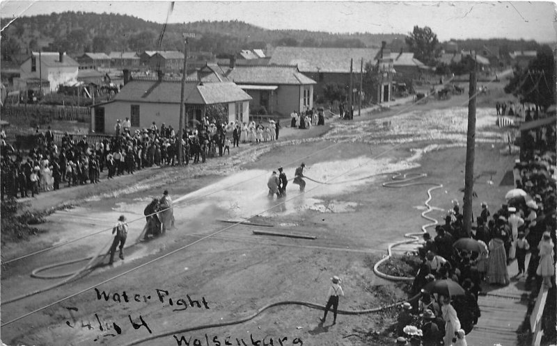 J38/ Walsenburg Colorado RPPC Postcard c1910 Water Fight Hoses Crowd 68
