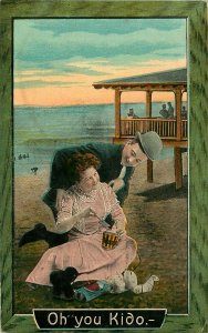 OH YOU KIDO MAN & WOMAN ON BEACH WITH SAND BUCKET TOYS ROMANCE POSTCARD c1910s