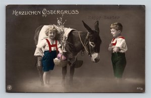 1920's RPPC Children Donkey Basket Eggs Hearty Easter Greetings Postcard