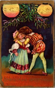 Christmas Postcard Boy and Girl Kissing Under Mistletoe and Lanterns