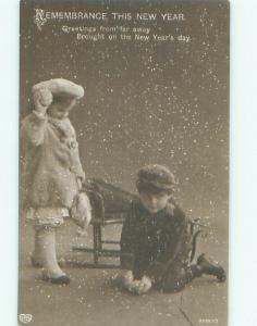 rppc 1920's New Year GIRL IS THROWING SNOWBALLS AT BROTHER AC8549