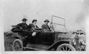 Postcard RPPC Three men in automobile wearing hats Circa 1910 23-9832