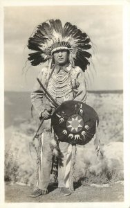 RPPC Native American Man in Buckskin & Eagle Headdress w/ Ceremonial Shield