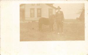 Barnum Iowa~Man Posing with Pony~House Bknd~Note on Bk~Webster County~c1910 RPPC