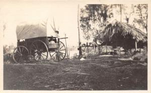 Swift Minnesota~Coverd Wagon Parked by Thatched Hut~c1910 Real Photo Postcard