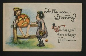 1917 Halloween Postcard Boy w/ Large Jack-O'-Lantern Sitting on Fence Near Girl