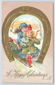 Christmas~Girls Sledding In Snow Thru Gold Horseshoe Portal~Emboss~1909 Postcard