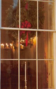 On Christmas Eve in a White House window, a candle flame flickered its beamin...