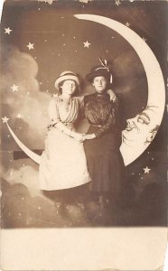 Two Women Posing on Moon Backdrop Two Women Posing on Moon Backdrop